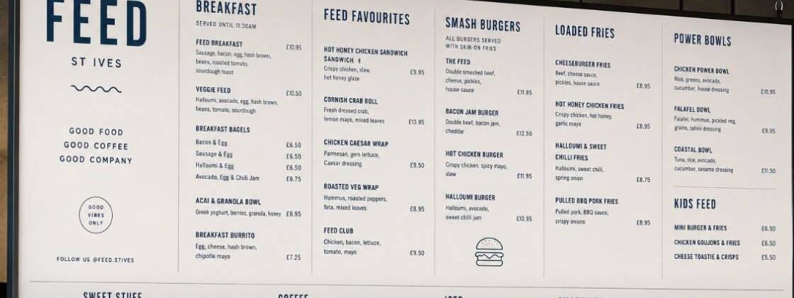 Feed St Ives menu board hanging above the cafe counter